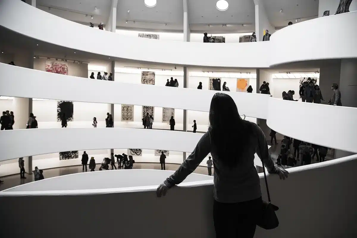 Empty exhibition gallery with display cases and informational panels about a maritime Madonna; dim ambient light, no people