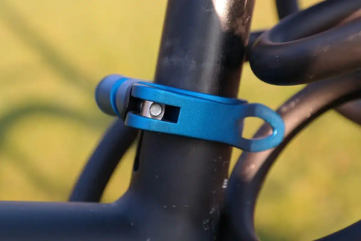 Close-up of an anonymous pair of hands adjusting a telescopic mobile controller clamp, no faces visible, neutral background; subtle reflection on metal clamps