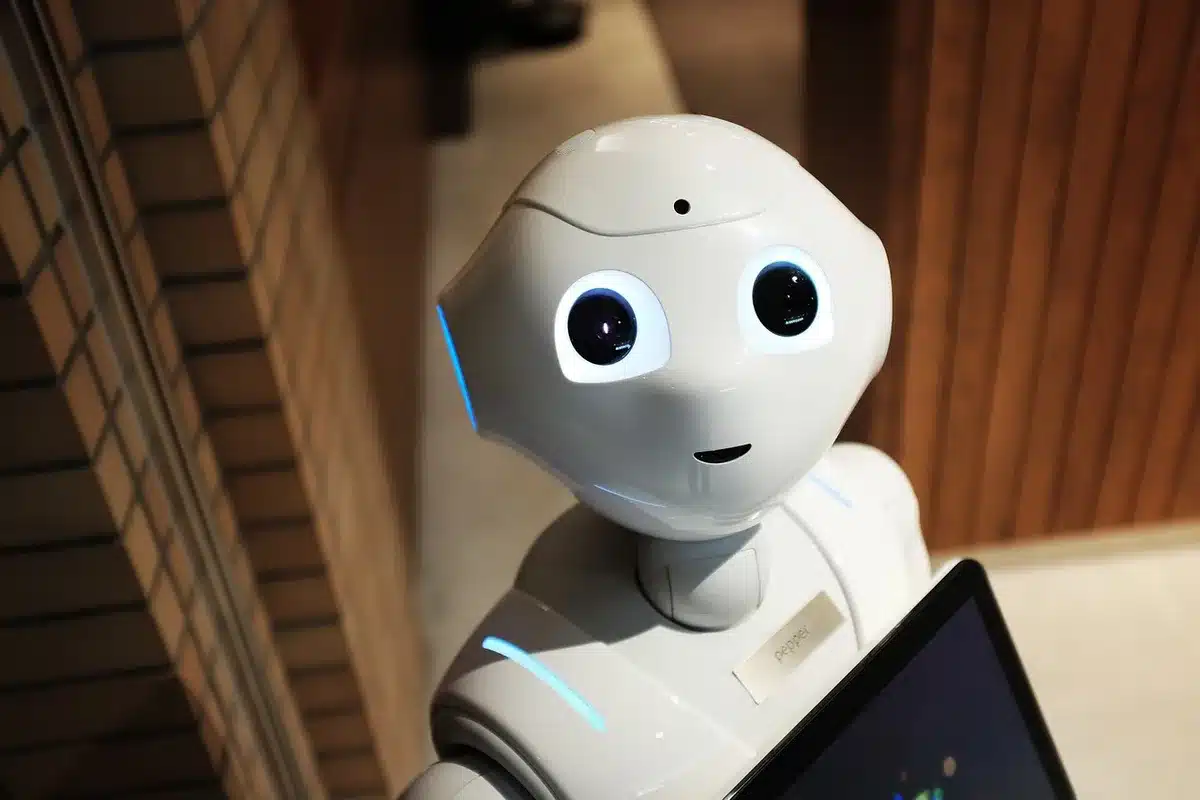anonymous blurred ecommerce customer at home interacting with voice assistant near laptop
