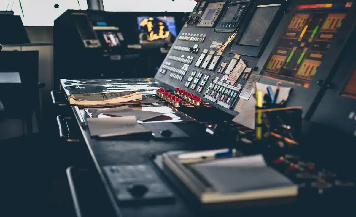 empty television control room with anonymous staff monitoring multiple screens showing generic channel grids