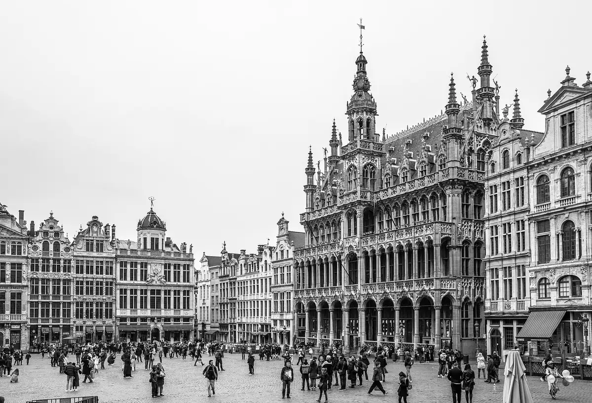 Anonymous person viewing a UNESCO-listed old town square with historic buildings