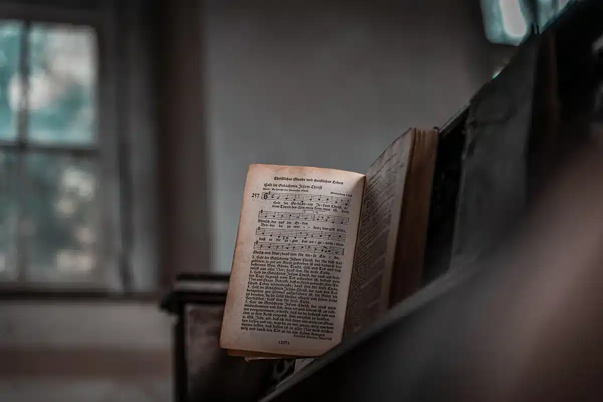 Close-up of an anonymous hand holding a printed speech page on a wooden desk, no logos or names visible