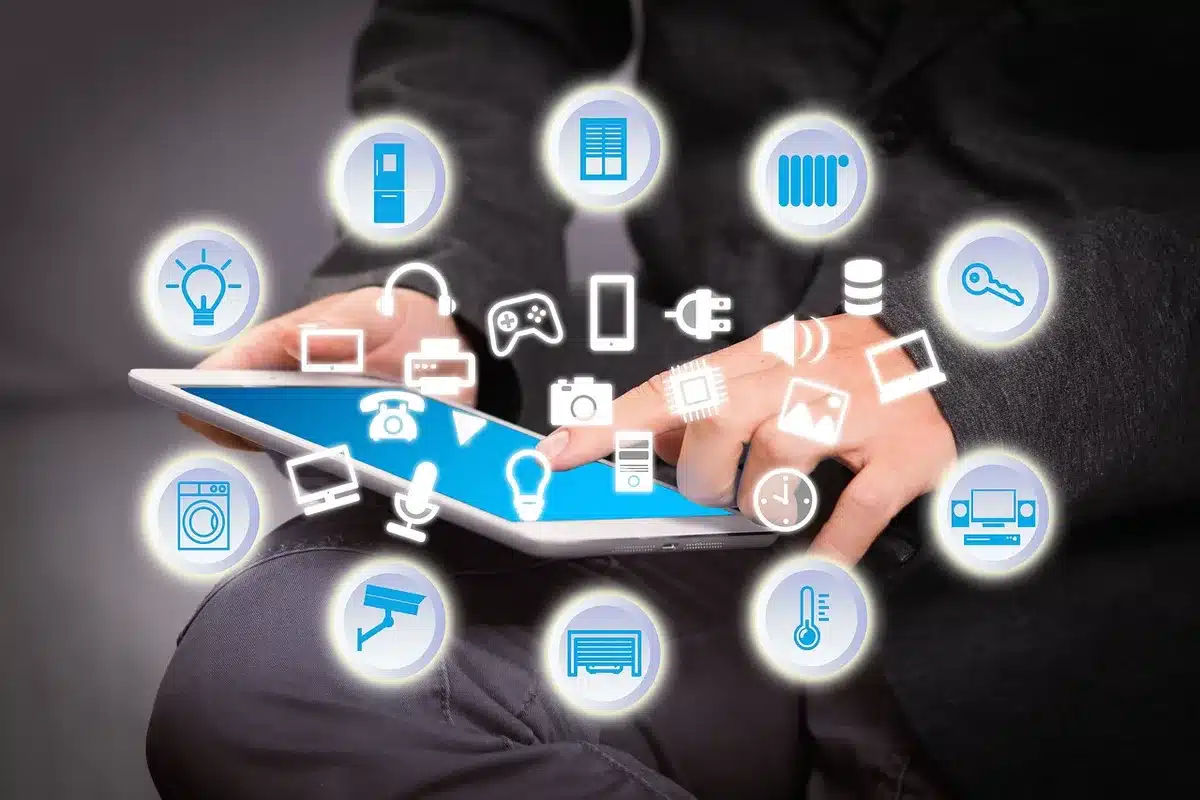 Close-up of an anonymous hand touching a generic smart-home app on a tablet on a kitchen counter, no brand