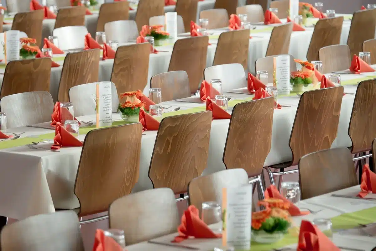 Empty royal dining hall set for a formal state meal, long banquet table with candles and place settings, no people