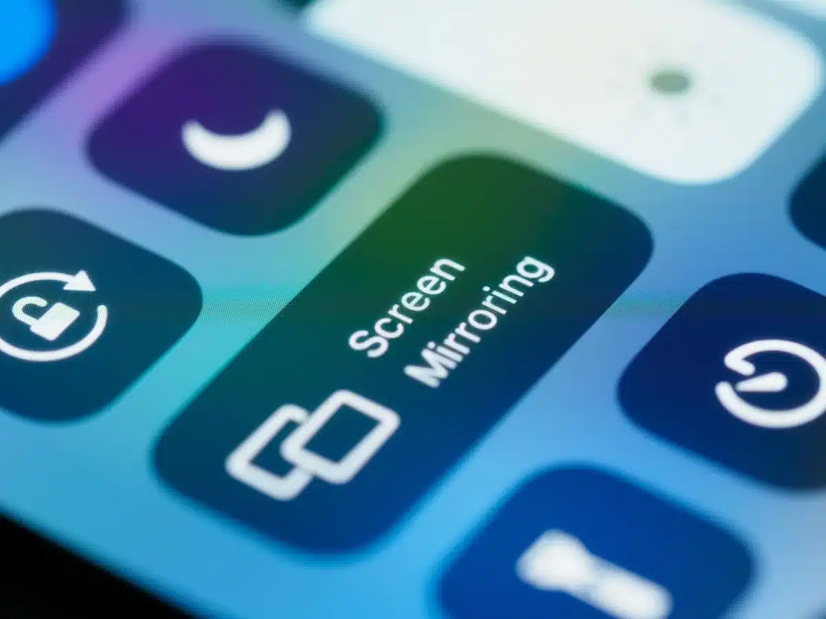 Anonymous hands holding a smartphone showing a generic settings screen, no brand visible