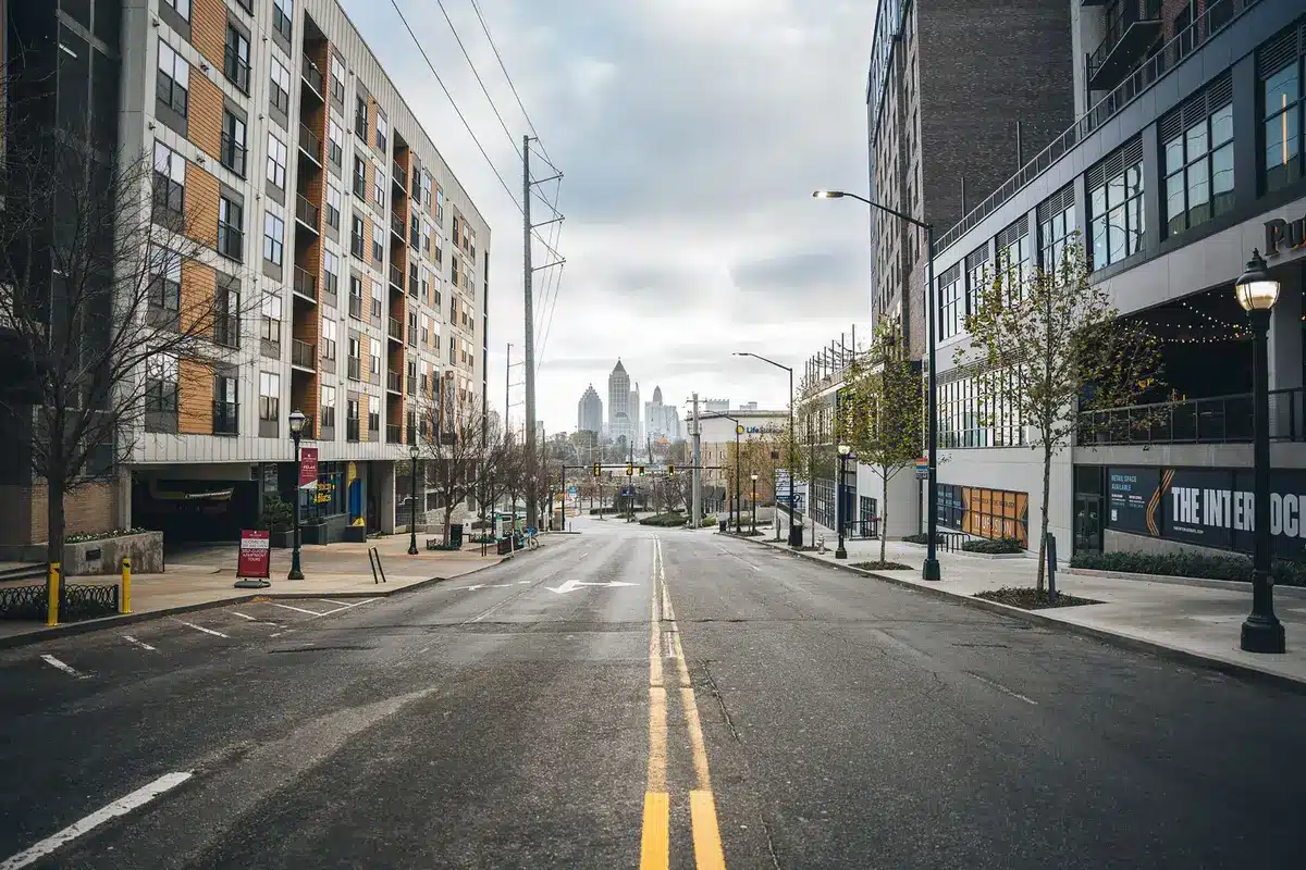 Empty neighborhood street at dusk with a single closed-front home and a lone child's toy on the pavement, a quiet domestic scene hinting at a past crime